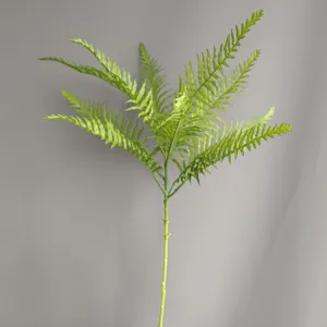 Artificial fern leaf detail shot, small single branch plant for home decor and floral arrangement.