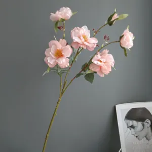 Artificial pink camellia flower branch for home decor, minimalist aesthetic floral arrangement.