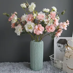 Artificial flower bouquet with green fluted vase, perfect for home decor and interior styling.