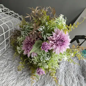 Detailed close-up view of artificial dahlia flower bouquet with green leaves for home decor.