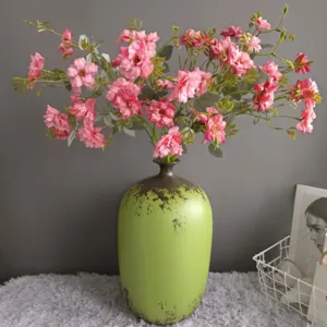 Nordic artificial wild rose flower bouquet with vintage green ceramic vase for home decor.