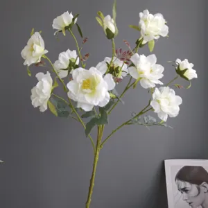 Artificial white wild rose camellia flower branch for home interior decoration details.