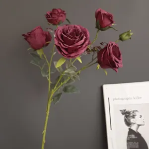 Close up of burgundy artificial rose bouquet with burnt edge design for home decor details.