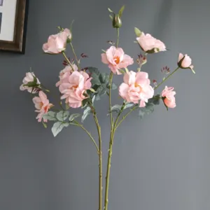 Artificial pink rose flowers fake floral stems for home room decor wedding party staging.