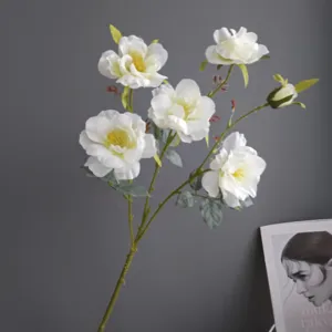 Artificial white flower detail shot, realistic camellia branch for modern home decor styling.