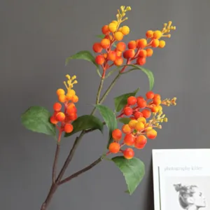 Close up of artificial foam berry branch, orange and yellow fruit detail for home decoration.