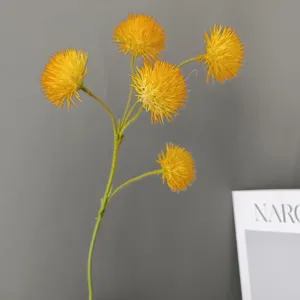 Detailed view of artificial yellow spherical flower stem, realistic floral decor accessory.