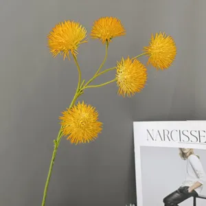 Close-up of artificial yellow allium flower stems for home decoration and floral design.