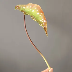 Artificial PU begonia maculata leaf detail, realistic spotted plant decor for home interior.