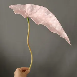 Close-up detail of the pink speckled artificial begonia leaf prop with stem for home decor.