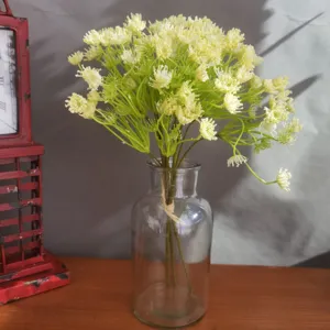 Artificial gypsophila flower bouquet in clear glass vase detailed view for home decor.