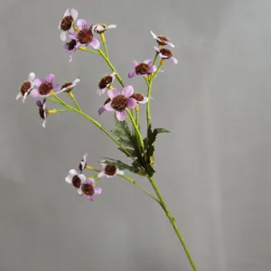 Close-up detail of artificial purple daisy flower branch with flocked center for home decor.