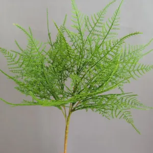 Primer plano detallado de rama de helecho artificial para decoración del hogar y arreglos.