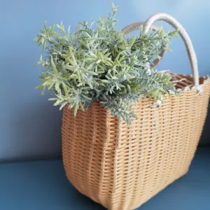 Detailed view of artificial rosemary plant in woven basket for Nordic home decor.