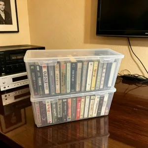 Transparent cassette storage box desktop plastic organizer container for audio tapes.