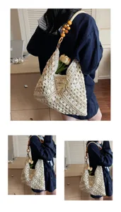 Handmade woven straw shoulder bag with wooden beads, stylish hollow beach handbag for women.
