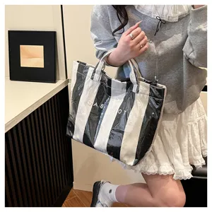 Black and white striped coated canvas tote bag, large capacity casual shoulder handbag.