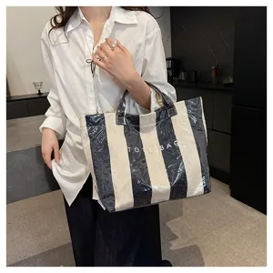 Stylish black and white striped coated canvas tote bag with clear layer and letter print.
