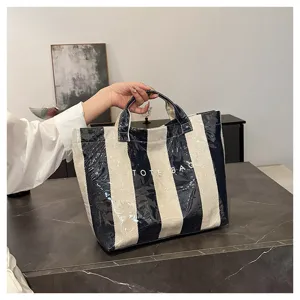 Detailed view of summer striped coated canvas tote bag, waterproof finish, large capacity.