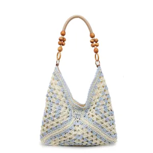 Handmade crochet straw shoulder bag with wooden bead handle, stylish hollow beach tote.