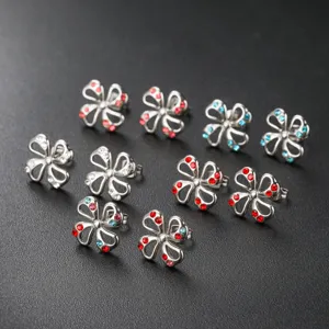Close-up detail of stainless steel flower stud earrings with sparkling colorful zircon stones.