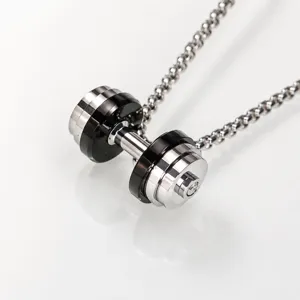 Close-up view of the fitness dumbbell pendant necklace showcasing intricate metallic details and finish.