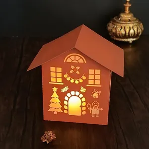 Close-up view of the glowing Christmas paper carved night light with hollow holiday designs.