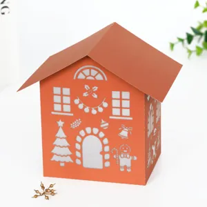 Laser-cut Christmas paper house detail view, festive hollow night light shade decor.