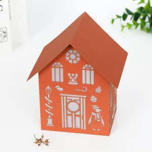 Laser cut paper christmas house night light detail view with hollow snowman and winter holiday patterns