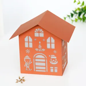 Detailed view of the laser-cut Christmas paper house lamp shade with hollow festive patterns.