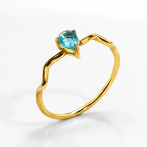 Gold-plated stainless steel wavy ring featuring a stunning pear-cut blue zircon detail.