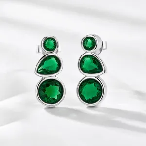 Detailed view of elegant silver earrings featuring three vertical green simulated gemstones.