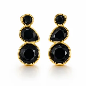 Elegant gold-plated drop earrings featuring three faceted black stones in a unique design.