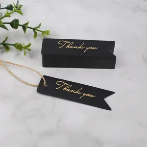 Black paper gift tags with gold foil thank you text and twine string for craft decor detail.