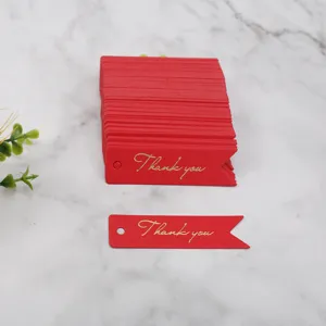 Red Thank You paper tags with gold foil stamping, swallowtail design for gift wrapping.