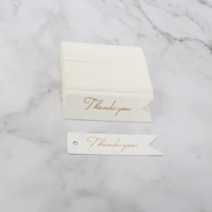 White swallowtail thank you paper tags detail view with elegant gold foil lettering.