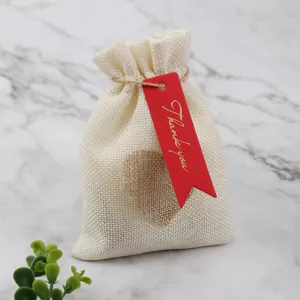 Jute burlap drawstring gift pouch with red thank you tag, ideal for jewelry and party favors.