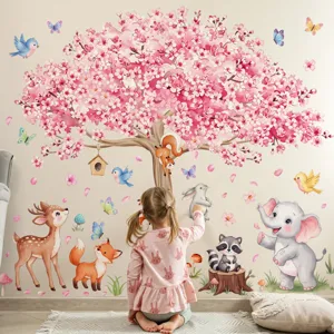 Close-up detail shot of cute cartoon animal and cherry tree wall sticker in kids room decor.