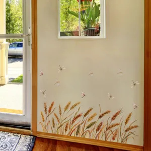 Close-up detail of wheat ear and dragonfly wall sticker in home interior background decor.