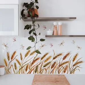 Close-up detail of watercolor wheat and dragonfly wall sticker in a bright kitchen scene.