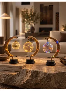 Detailed close-up of decorative crescent moon LED lamps with warm hanging lights in home decor.