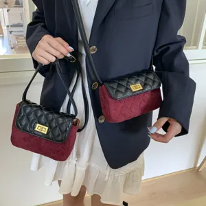 Detail view of the quilted suede crossbody bag with gold-tone turn lock closure and leather trim.