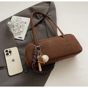 Brown suede baguette shoulder bag detail, vintage underarm bag with baseball keychain