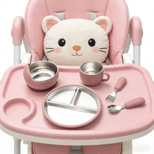 Stainless steel baby tableware detail, partitioned plate and bowl set on pink high chair.