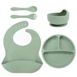 Silicone baby feeding set featuring divided plate, suction bowl, bib, spoon, and fork.