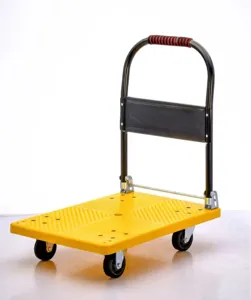 Foldable platform hand truck detail view showing yellow plastic deck and black folding handle.