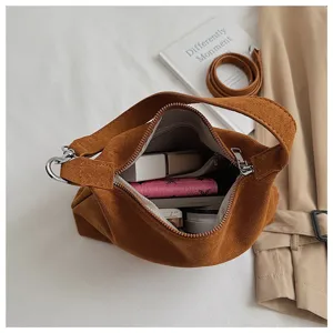 Detail view of brown suede underarm shoulder bag showing interior capacity and soft texture.