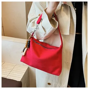 Red suede underarm shoulder bag for women, stylish minimalist hobo handbag with bead charms.