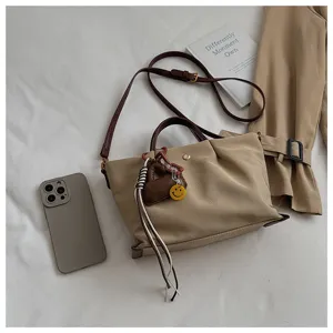 Khaki nylon crossbody shoulder bag for women, casual tote with adjustable strap and charm.