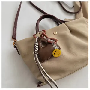 Nylon shoulder crossbody bag with cute pendant, versatile casual daily handbag for women.